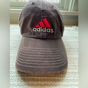 Adidas weathered grayish hat with red embroidery.